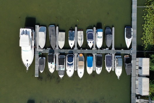 Aerial view of motorboats and yachts docked at the Aschaffenburger Bootsclub pier on the green water of the Main river in Aschaffenburg Bayern Germany. Aerial view of motorboats and yachts docked at the Aschaffenburger Bootsclub pier on the green water of the Main river in Aschaffenburg Bayern Germany.