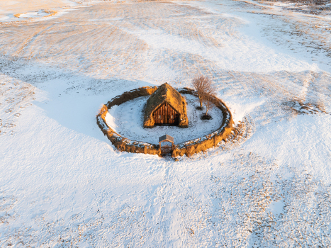 Aerial view of Grafarkirkja a historic turf church surrounded by a circular stone wall in a snow covered landscape in Hofsos Skagafjordur Iceland. Aerial view of Grafarkirkja a historic turf church surrounded by a circular stone wall in a snow covered landscape in Hofsos Skagafjordur Iceland.