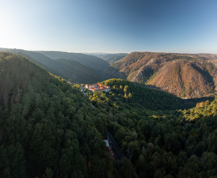 Aerial view of the Monastery of Santo Estevo de Ribas de Sil nestled in the lush green forests of the Ribeira Sacra canyon in O Covelo Ourense Spain.