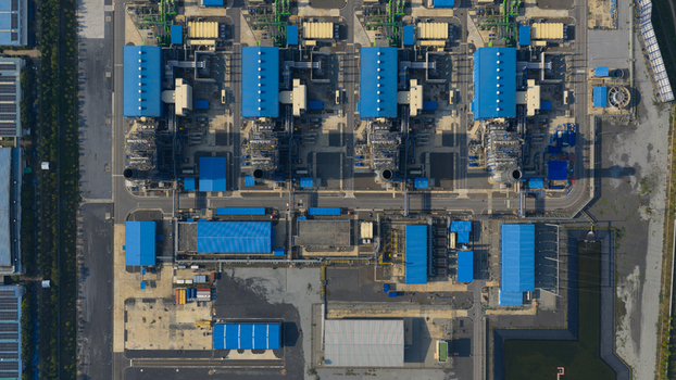 Aerial view of the Gulf PD Power Plant industrial complex with blue roofed buildings and cooling towers in Map Yang Phon Rayong Thailand. Aerial view of the Gulf PD Power Plant industrial complex with blue roofed buildings and cooling towers in Map Yang Phon Rayong Thailand.