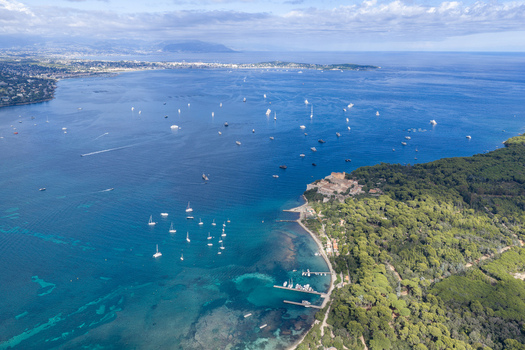 Aerial view of Ile Sainte Marguerite with Fort Royal dense pine forests turquoise waters and yachts anchored in the bay of Cannes Provence Alpes Cote d Azur France. Aerial view of Ile Sainte Marguerite with Fort Royal dense pine forests turquoise waters and yachts anchored in the bay of Cannes Provence Alpes Cote d Azur France.