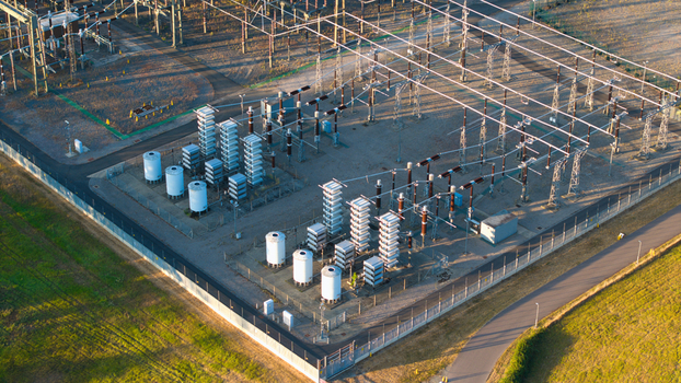 Aerial view of Grendon national grid station featuring electrical transformers switchgear and power infrastructure surrounded by a perimeter fence in Northampton England United Kingdom. Aerial view of Grendon national grid station featuring electrical transformers switchgear and power infrastructure surrounded by a perimeter fence in Northampton England United Kingdom.