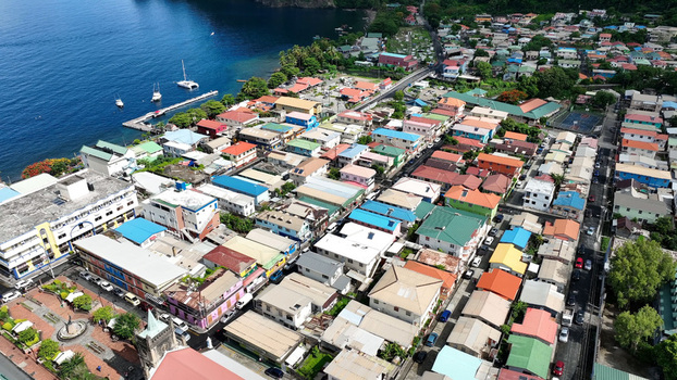 Aerial view of the colorful coastal town of Soufriere with its historic church dense residential buildings and boats docked in the harbor in Soufriere Soufriere Saint Lucia. Aerial view of the colorful coastal town of Soufriere with its historic church dense residential buildings and boats docked in the harbor in Soufriere Soufriere Saint Lucia.