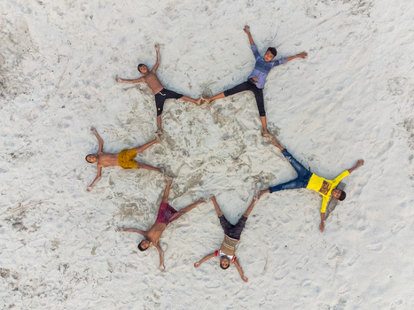 Alakjhari Bangladesh 26 July 2026 Aerial view of children lying on the sand in a star formation at Jharbari ghat.