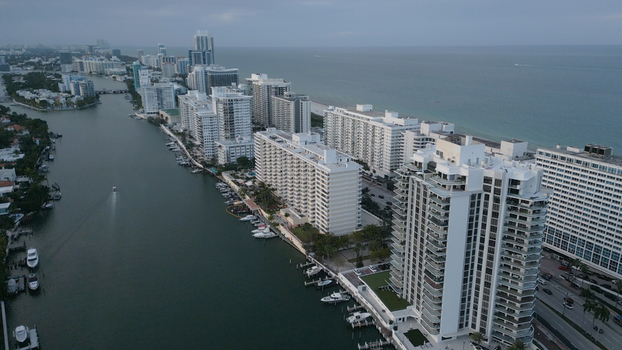 Aerial view of Miami Beach skyline featuring high rise residential buildings along the canal and the Atlantic Ocean in Miami Beach Florida United States. Aerial view of Miami Beach skyline featuring high rise residential buildings along the canal and the Atlantic Ocean in Miami Beach Florida United States.