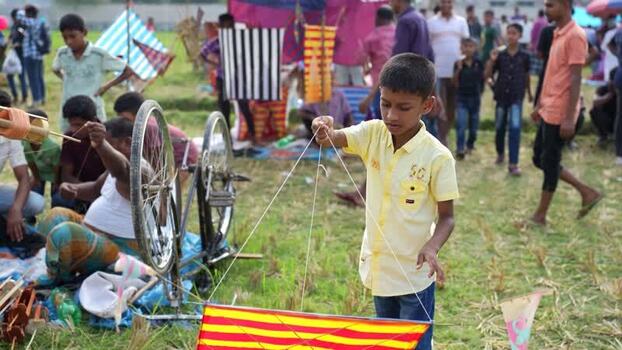 View of a boy with a kite at a festival in Bogura Bangladesh. View of a boy with a kite at a festival in Bogura Bangladesh.
