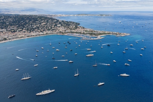 Aerial view of Ile Sainte Marguerite and numerous yachts and luxury boats anchored in the blue Mediterranean Sea off the coast of Cannes Provence Alpes Cote d Azur France. Aerial view of Ile Sainte Marguerite and numerous yachts and luxury boats anchored in the blue Mediterranean Sea off the coast of Cannes Provence Alpes Cote d Azur France.