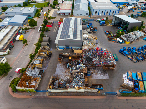 Aerial view of the Neuenstein Techno Zone featuring an industrial recycling facility with scrap metal piles and warehouse buildings in Neuenstein Baden Wurttemberg Germany. Aerial view of the Neuenstein Techno Zone featuring an industrial recycling facility with scrap metal piles and warehouse buildings in Neuenstein Baden Wurttemberg Germany.