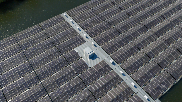Aerial view of a large floating solar panel farm on a lake with central maintenance walkways and infrastructure in Zwolle Overijssel Netherlands. Aerial view of a large floating solar panel farm on a lake with central maintenance walkways and infrastructure in Zwolle Overijssel Netherlands.