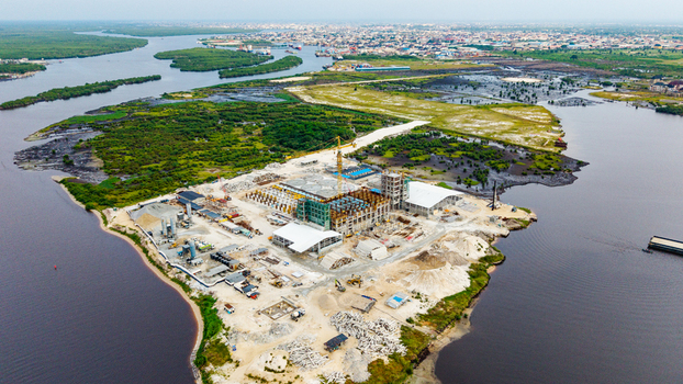 Aerial view of a construction site in Satellite Town with industrial buildings a crane and material stockpiles on a peninsula in the Lagos Lagoon Lagos Lagos Nigeria.