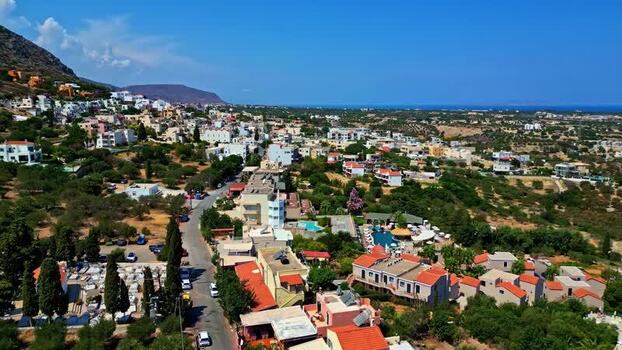 Aerial view of Crete town with houses and greenery Greece.