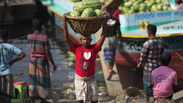 View of a man carrying watermelons at Sadarghat Bangladesh.