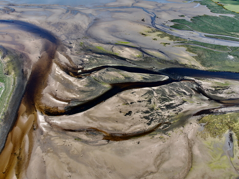 Aerial view of the winding dark water channels and textured sandbanks of Findhorn Bay Findhorn Scotland United Kingdom. Aerial view of the winding dark water channels and textured sandbanks of Findhorn Bay Findhorn Scotland United Kingdom.