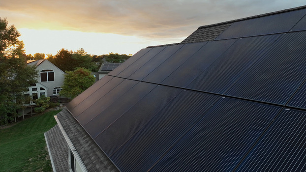 Aerial view of solar panels installed on a residential roof during a golden autumn sunset in Rothsville Pennsylvania United States.