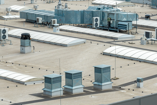 Aerial view of a warehouse rooftop featuring advanced HVAC systems ventilation units and skylights in Warszawa Mazowieckie Voivodeship Poland. Aerial view of a warehouse rooftop featuring advanced HVAC systems ventilation units and skylights in Warszawa Mazowieckie Voivodeship Poland.