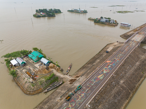 Mithamain Bangladesh 10 September 2025 Aerial view of the Mithamain road decorated with colorful alpona art surrounded by village islands and boats in the haor region. Mithamain Bangladesh 10 September 2025 Aerial view of the Mithamain road decorated with colorful alpona art surrounded by village islands and boats in the haor region.