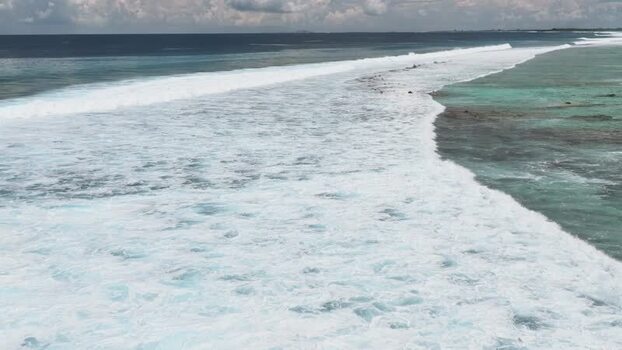 Aerial view of waves breaking over a coral reef Maldives. Aerial view of waves breaking over a coral reef Maldives.
