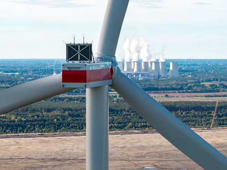 Aerial view of a wind turbine at Windpark Forst Briesnig II with the Janschwalde Power Plant in the background on recultivated land in Forst Brandenburg Germany. Aerial view of a wind turbine at Windpark Forst Briesnig II with the Janschwalde Power Plant in the background on recultivated land in Forst Brandenburg Germany.