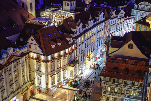 Aerial view of the historic city center of Prague at night with illuminated buildings cobblestone streets and glowing rooftops in Prague Prague Czechia. Aerial view of the historic city center of Prague at night with illuminated buildings cobblestone streets and glowing rooftops in Prague Prague Czechia.