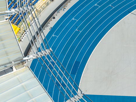 Aerial view of the athletic stadium featuring blue running tracks and modern roof structure in Chorzow Wojewodztwo slaskie Poland.
