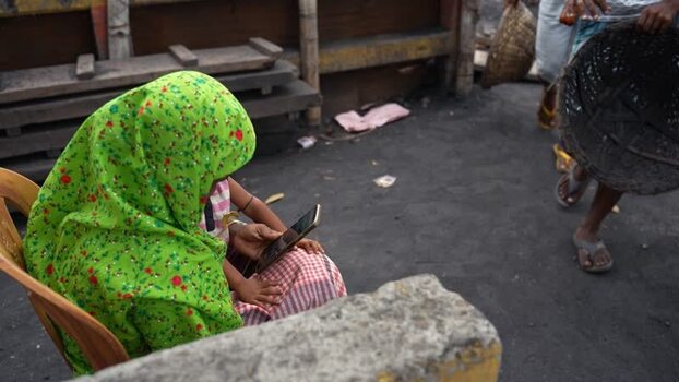 View of a woman using a smartphone in Aminbazar Bangladesh.