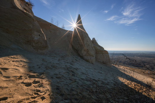 View of the sandstone rock formations at Sandberg with a sun starburst behind a sharp peak under a clear blue sky Bratislava IV Bratislava Region Slovakia. View of the sandstone rock formations at Sandberg with a sun starburst behind a sharp peak under a clear blue sky Bratislava IV Bratislava Region Slovakia.