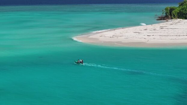 Aerial view of a boat in turquoise waters near a beach Maldives. Aerial view of a boat in turquoise waters near a beach Maldives.