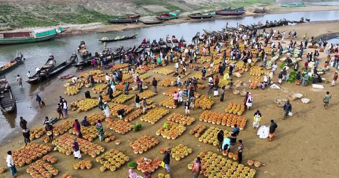 Aerial view of a busy riverbank market in Sylhet Bangladesh.