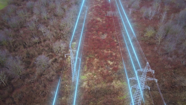Aerial view of High voltage power lines and pylons with electricity flow. Smart grid energy transmission and electric infrastructure concept Aerial view of High voltage power lines and pylons with electricity flow. Smart grid energy transmission and electric infrastructure concept