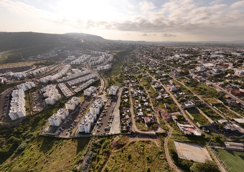 Santiago de Queretaro Mexico 25 September 2026 Aerial view of Anillo Vial Fray Junipero Serra winding through residential apartment complexes and urban sprawl under a soft morning sky.