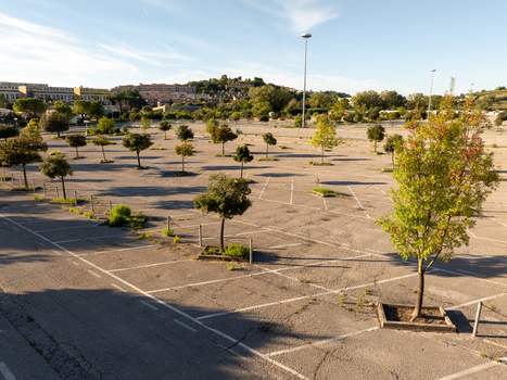 Aerial view of an empty parking lot with scattered trees and marked parking spaces in Ancona Marche Italy. Aerial view of an empty parking lot with scattered trees and marked parking spaces in Ancona Marche Italy.