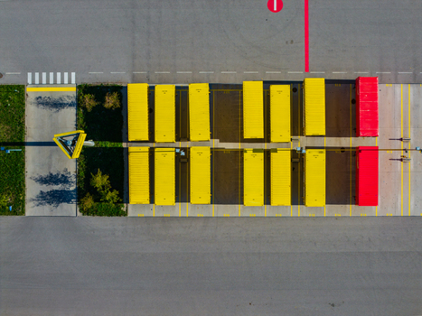 Aerial view of Logistikzentrum Allhaming with rows of yellow and red shipping containers in a paved logistics yard with marked parking spaces in Allhaming Oberosterreich Austria. Aerial view of Logistikzentrum Allhaming with rows of yellow and red shipping containers in a paved logistics yard with marked parking spaces in Allhaming Oberosterreich Austria.