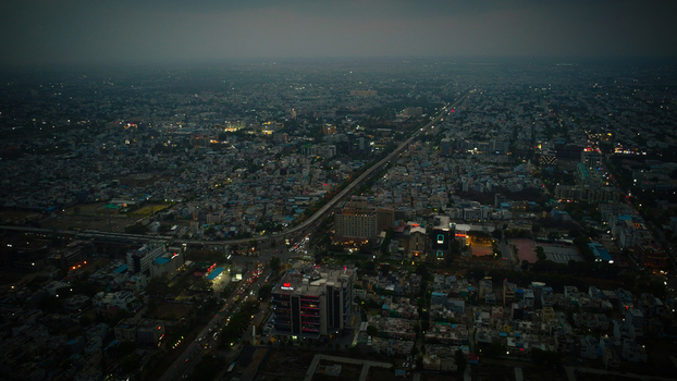 Mumbai India 16 May 2025 View of the sprawling urban landscape of Mumbai from an aerial perspective at dusk with city lights and a long highway stretching into the distance.