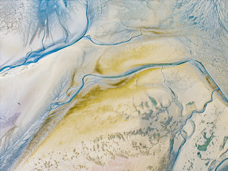 Aerial view of the intricate tidal channels and sandbanks of the Baie de Somme showcasing the unique patterns of water and sediment in Saint Valery sur Somme Hauts de France France. Aerial view of the intricate tidal channels and sandbanks of the Baie de Somme showcasing the unique patterns of water and sediment in Saint Valery sur Somme Hauts de France France.