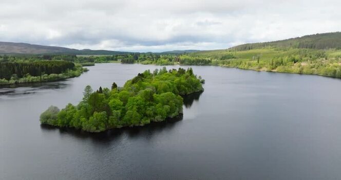 Aerial view of a wooded island on a lake United Kingdom. Aerial view of a wooded island on a lake United Kingdom.
