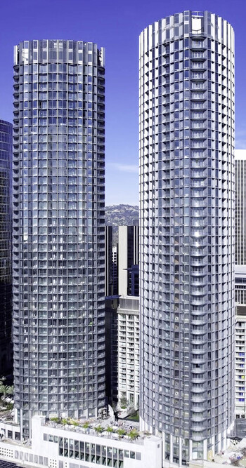 Aerial view of the modern cylindrical residential towers with glass facades and balconies in the urban landscape of Century City California United States.