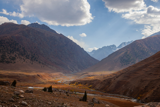 View of Astore Valley with rugged mountain slopes a winding river and autumn foliage under a bright sky in Astore Gilgit Pakistan. View of Astore Valley with rugged mountain slopes a winding river and autumn foliage under a bright sky in Astore Gilgit Pakistan.