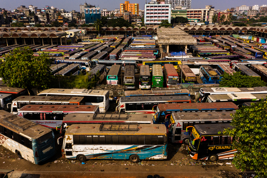 Aerial view of the busy Gabtoli Bus Terminal with numerous buses parked in rows in the urban landscape of Dhaka Dhaka Division Bangladesh.
