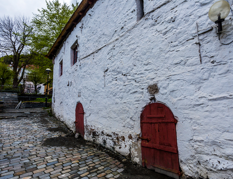 View of aged white stone walls meet cobblestone streets and vibrant red arched doorways painting a scene of rustic charm West Old Town New Mexico Sweden. View of aged white stone walls meet cobblestone streets and vibrant red arched doorways painting a scene of rustic charm West Old Town New Mexico Sweden.