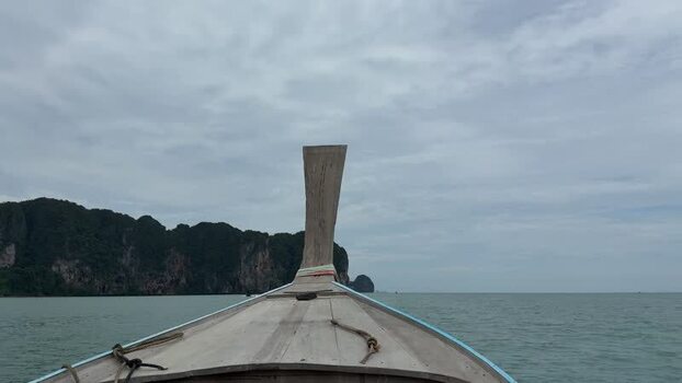 View of a longtail boat and limestone karsts Thailand.