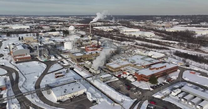 Aerial view of an industrial facility with smoking chimneys United States. Aerial view of an industrial facility with smoking chimneys United States.