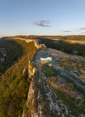 Aerial view of the historic Ovech Fortress perched on a rocky plateau with the Bulgarian flag flying in the golden hour light in Provadia Varna Bulgaria. Aerial view of the historic Ovech Fortress perched on a rocky plateau with the Bulgarian flag flying in the golden hour light in Provadia Varna Bulgaria.