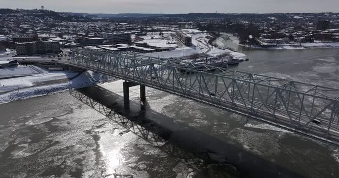 Aerial view of a steel truss bridge over the icy Ohio River United States. Aerial view of a steel truss bridge over the icy Ohio River United States.