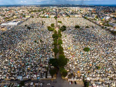 Aerial view of Maximo Gomez National Cemetery with dense rows of graves and a central tree lined path in the urban landscape of Santo Domingo Distrito Nacional Dominican Republic. Aerial view of Maximo Gomez National Cemetery with dense rows of graves and a central tree lined path in the urban landscape of Santo Domingo Distrito Nacional Dominican Republic.