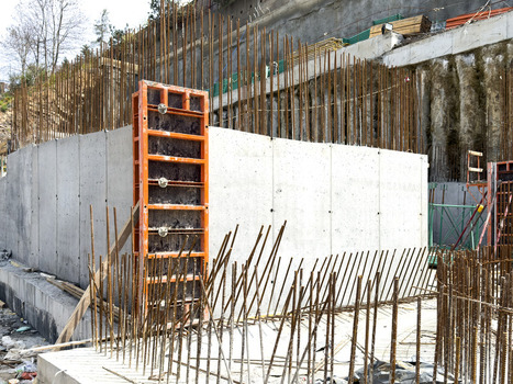 View of concrete walls and vertical steel rebar at a construction site with orange formwork Sariyer Istanbul Turkiye. View of concrete walls and vertical steel rebar at a construction site with orange formwork Sariyer Istanbul Turkiye.