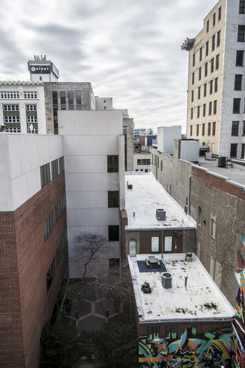 View of the urban architecture and alleyways of the downtown district with brick facades and a small courtyard under an overcast sky in Lincoln Nebraska United States.