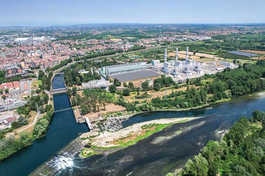Aerial view of the power plant and Parco Fluviale del Bricel situated along the Po river with urban surroundings in Chivasso Piemonte Italy. Aerial view of the power plant and Parco Fluviale del Bricel situated along the Po river with urban surroundings in Chivasso Piemonte Italy.