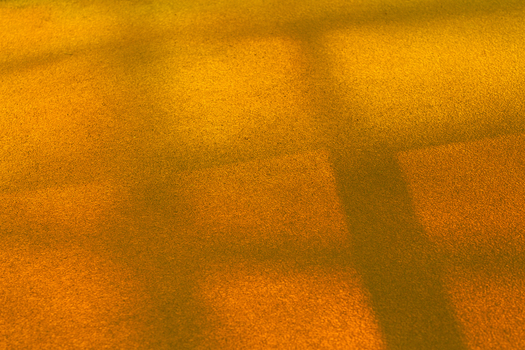 View of geometric shadows cast in warm hues across a textured ground creating a mesmerizing dance of light and form La Defense Flevoland Netherlands. View of geometric shadows cast in warm hues across a textured ground creating a mesmerizing dance of light and form La Defense Flevoland Netherlands.