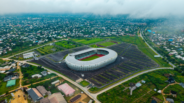 Aerial view of Godswill Akpabio Stadium surrounded by urban sprawl green fields and cloudy skies in Uyo Akwa Ibom Nigeria. Aerial view of Godswill Akpabio Stadium surrounded by urban sprawl green fields and cloudy skies in Uyo Akwa Ibom Nigeria.