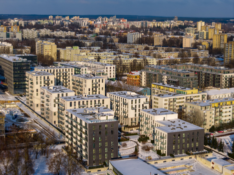 Aerial view of modern residential apartment blocks and urban housing under a light layer of snow in Vilnius County Lithuania.